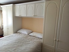 Wardrobe run of 3 with over bed storage