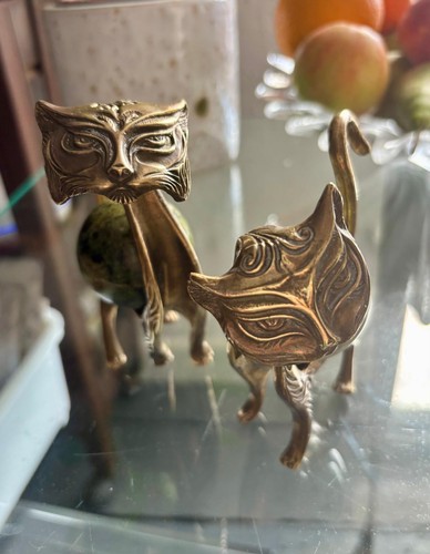 Couple cats brass with the - of,