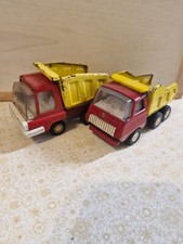 Two vintage Tonka small tipper trucks. Good play worn condition. Pressed steel.