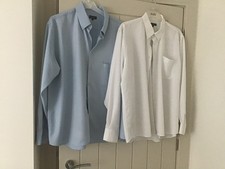 2 light blue and white mens shirts