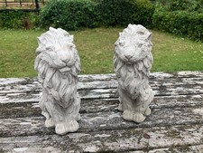 A PAIR OF NICELY  DETAILED  STONE GARDEN LION ORNAMENTS 29cm TALL  OVER 3kg EACH