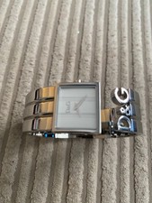 DOLCE & GABBANA STAINLESS STEEL LAIES WATCH. SUARE DIAL CUFF BRACELET STYLE