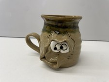 A PRETTY UGLY POTTERY MUG -