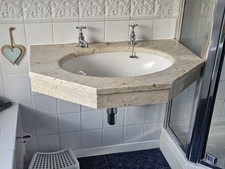 bathroom sink with stone surround, possibly marble