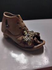 An Old Fashioned Pottery Boot With A Mouse Peeking Out Of It