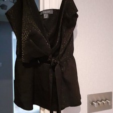 Primark little black sleeveless top with shoe string straps and tie up front....