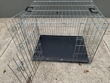 Dog crate medium size. Very good condition . Two doors
