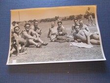 Men in trunks on grass