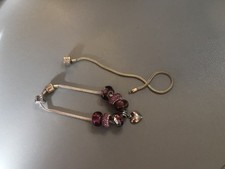 A pre owned Rhona Sutton charm bracelet + ane extra bracelet