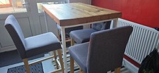 Rustic breakfast bar/table with four bar chairs. 