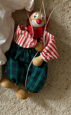 wooden clown puppet marionette. green checked trousers.