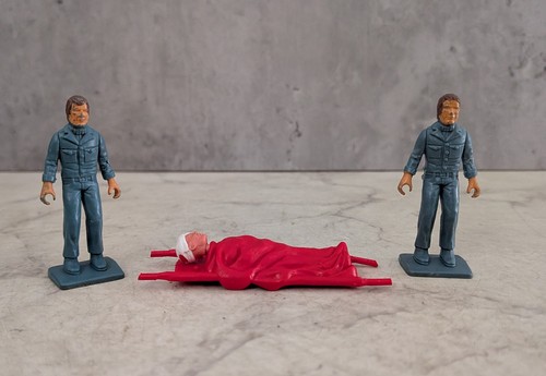 Two figures with stretcher - two,