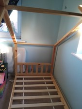 Single pine canopy bed frame.