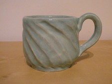 Studio Art Pottery Stoneware twisted and faceted turquoise mug 8cm diameter