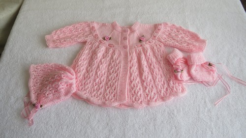 Hand knitted pink layette - hand,