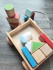 children building toy large wooden building bricks and wooden cart