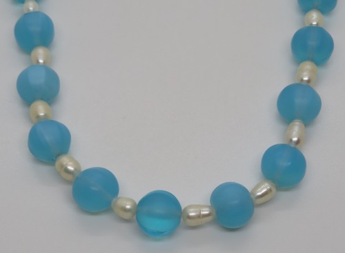 Blue glass and cultured pearl