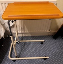 Overbed table with castor wheels adjustable height