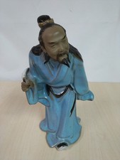 Chinese Shiwan Kidman Figurine Wearing Blue Robe And Holding A Feather Quill