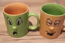 pair of vintage funny face trade wind cups