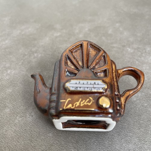 Brown ceramic tiny - teapot", by