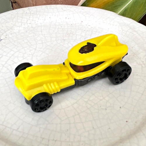 Yellow black plastic toy - &,