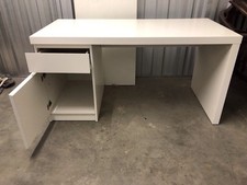 Large white Ikea desk with one drawer and a cupboard