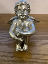 silver-colored Resin angel or