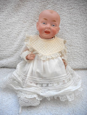 Antique porcelain doll  german  baby. unmarked...12inches all original dressed.