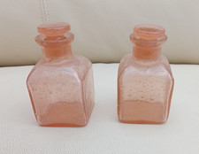 A pair of very old pink glass