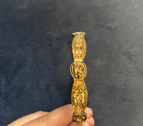 Gold tone bangle - tone,