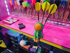 space man sitting darts stand
