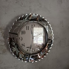 Mirrored wall clock with scallopped edges and inset engraving