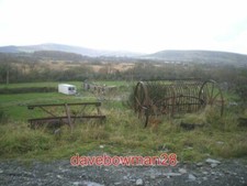 PHOTO  ABANDONED FARM MACHINERY THESE OLD RAKES AND TILLS LIE JUST OFF THE ACCES