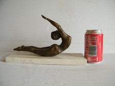 Bronze sculpture of woman exercising.