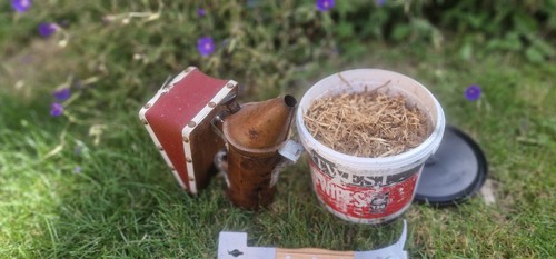 Beeking smoker and hive - and,