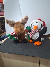 A Pair Of Singing Christmas Characters With Animated Rheindeer