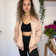 Pretty in pink lightweight baby pink satin bomber jacket with rose gold accents.