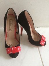 Red herring suede shoes with white polka dots and red bow. Black & red heels.
