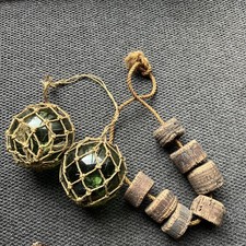 A PAIR VINTAGE GREEN GLASS FISHERMAN FLOATS / HEMP NET & CORK FLOATS ON STRING  