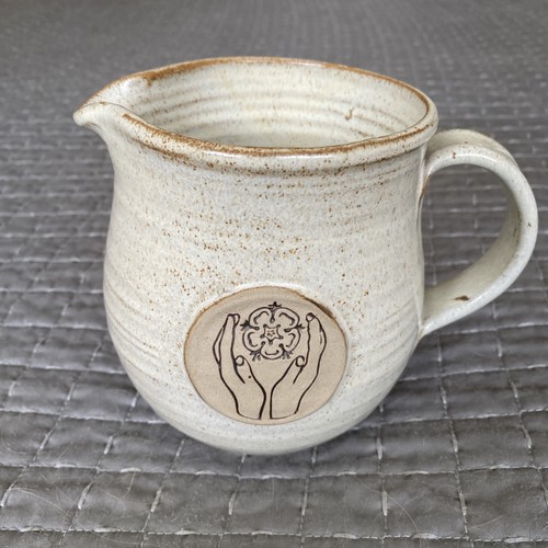 Pitcher pottery with hands and - with,