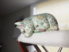 Floral patterned china cat figure paper mache effect.