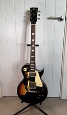 Vintage V100MRBK Icon Series Distressed Black over Sunburst Electric Guitar