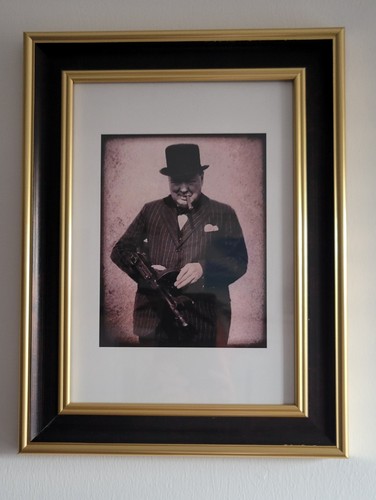 Black and gold framed portrait