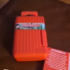 Monopoly Deal Card Game Shuffle Edition with Red Case and Instructions