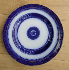 Flow blue stoneware geometric design dinner plate - maker’s name starting "pe"