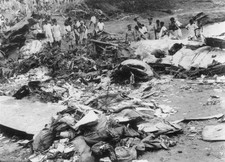 People standing among wreckage