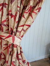 Beige curtains with a red modern leaf design