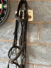 Brown leather Shires bridle with a hanging cheek snaffle bit, running martingale