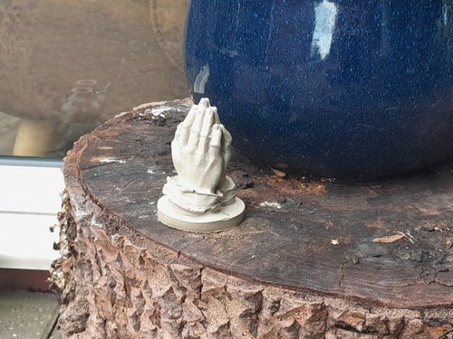Praying hands stone outside - praying,